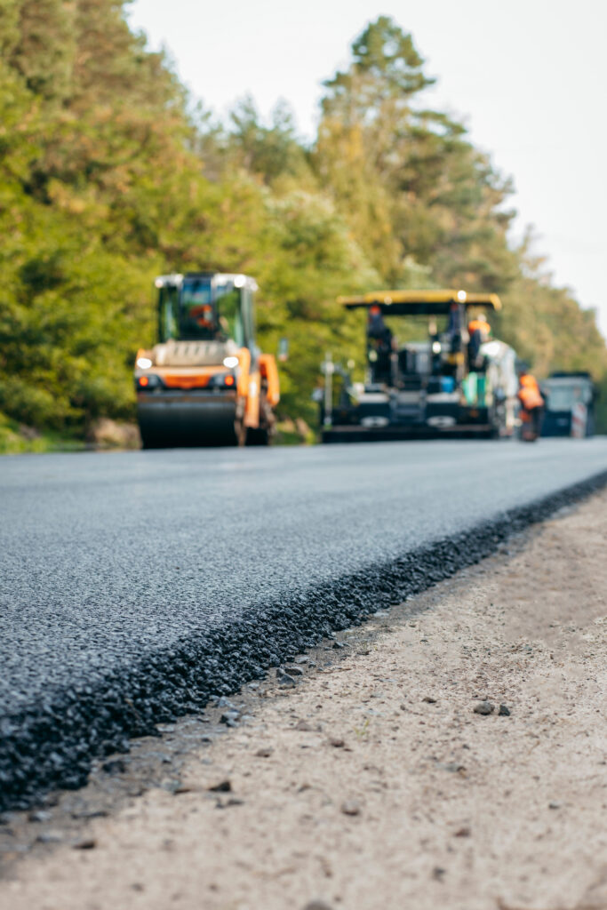 Vibratory asphalt rollers compactor compacting new asphalt pavement. Road service repairs the highway
